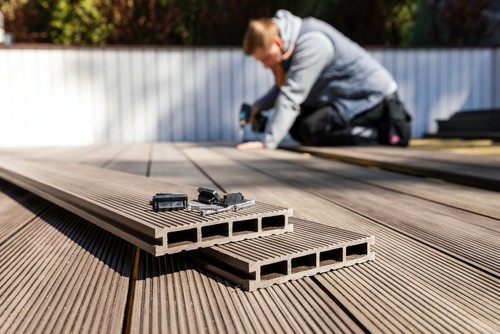 Wpc Terrace Construction - Worker Installing Wood Plastic Composite Decking