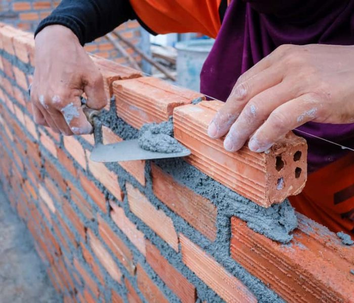 masonry contractor installing bricks.